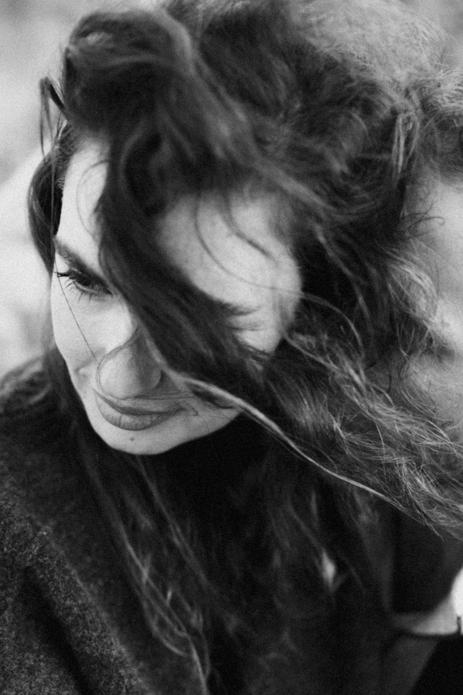 A series of black and white portraits showing flowing dark hair and dramatic shadows.