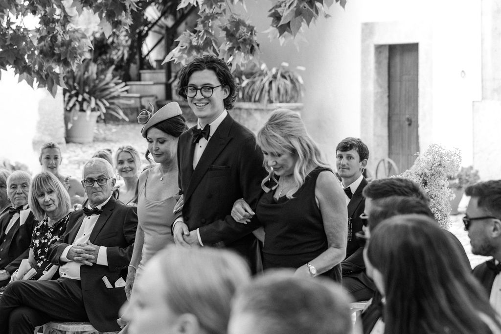 Wedding guests mingle and socialize during an outdoor cocktail reception.