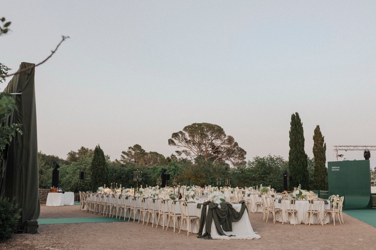 Aerial view of an outdoor wedding venue with tables arranged in geometric patterns.