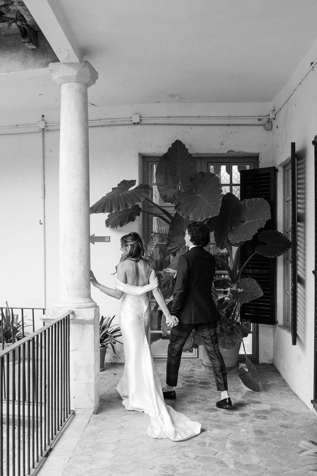 Black and white wedding photos showing couple dancing on a covered veranda.