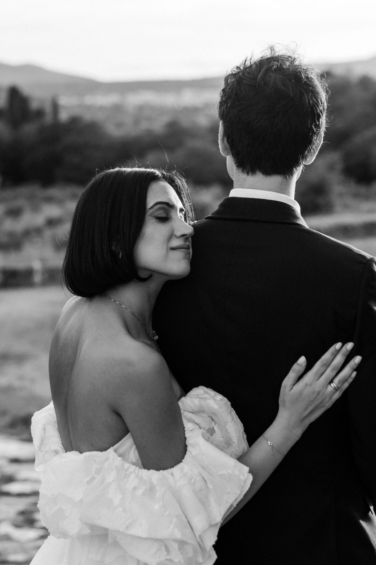 Black and white photo series showing intimate romantic moments between newlyweds outdoors.