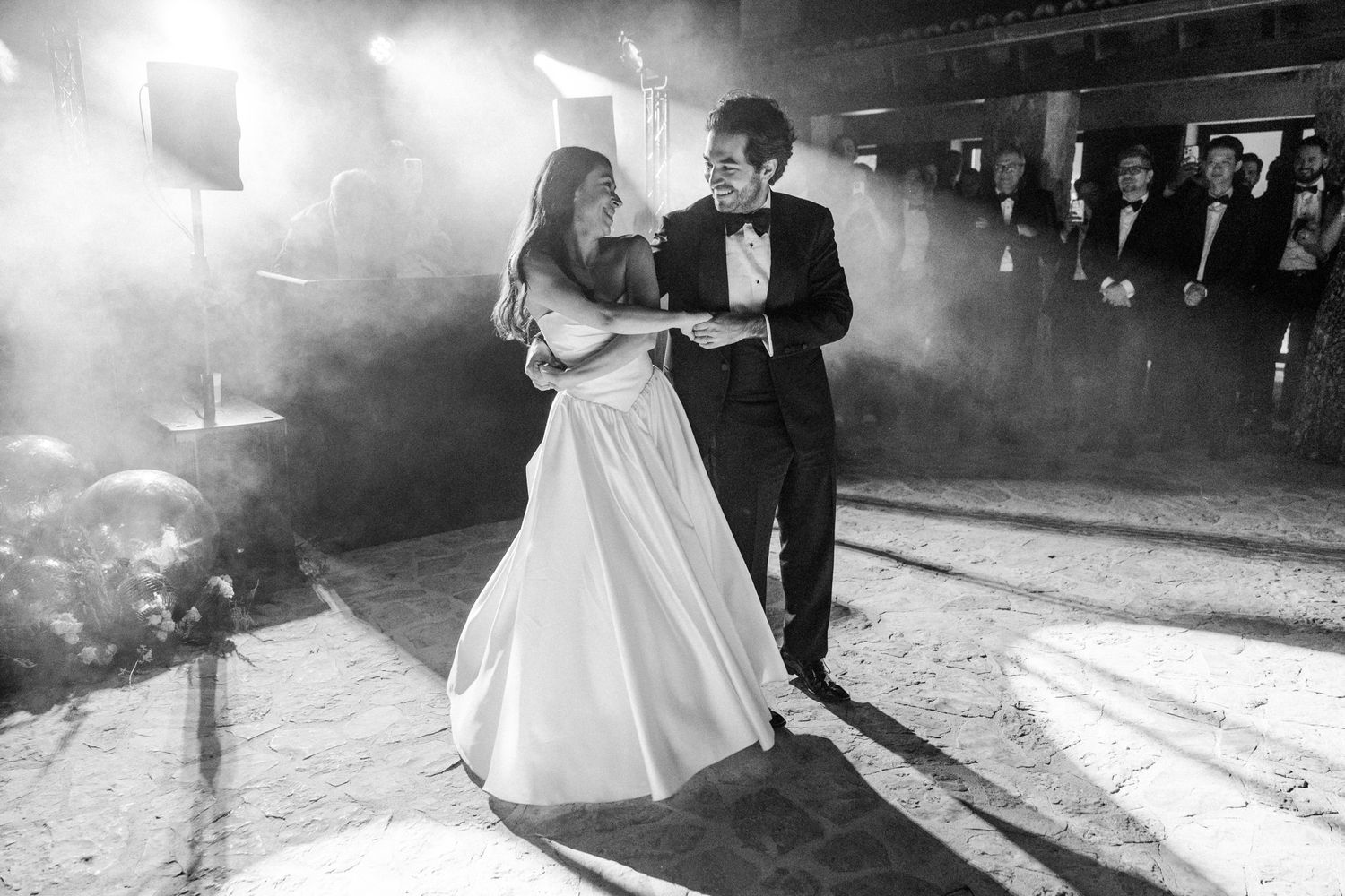A black and white wedding photo montage showing dancing and celebration moments on the dance floor.
