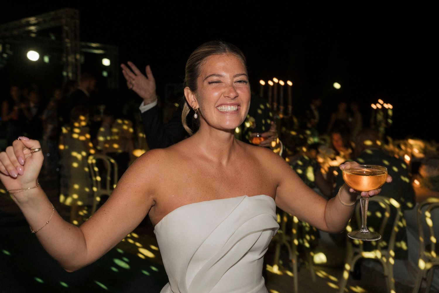 Wedding reception celebration with city lights glowing in background.