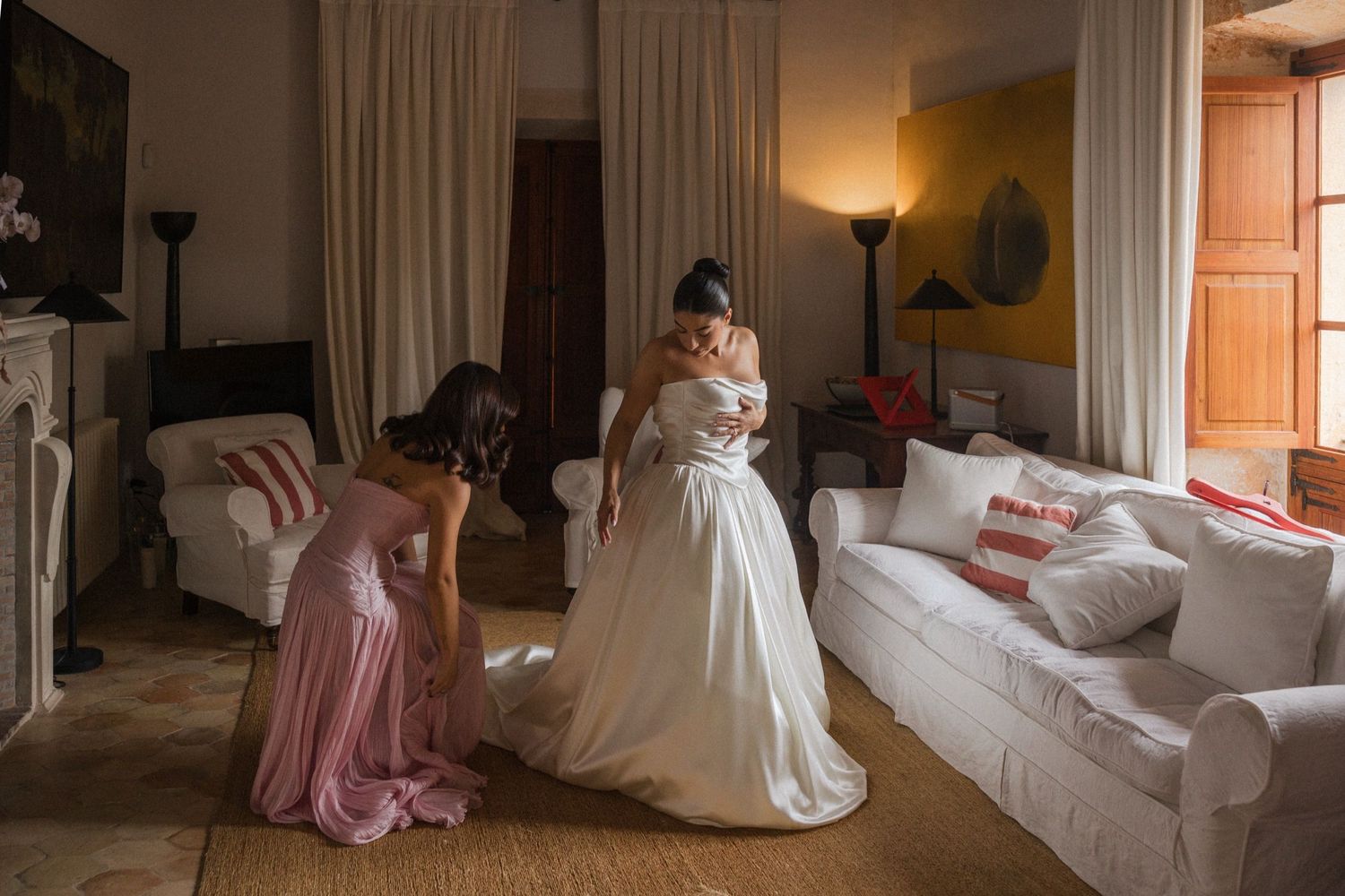 A collection of wedding preparation moments showing bridal gowns and dresses in warm-lit indoor settings.