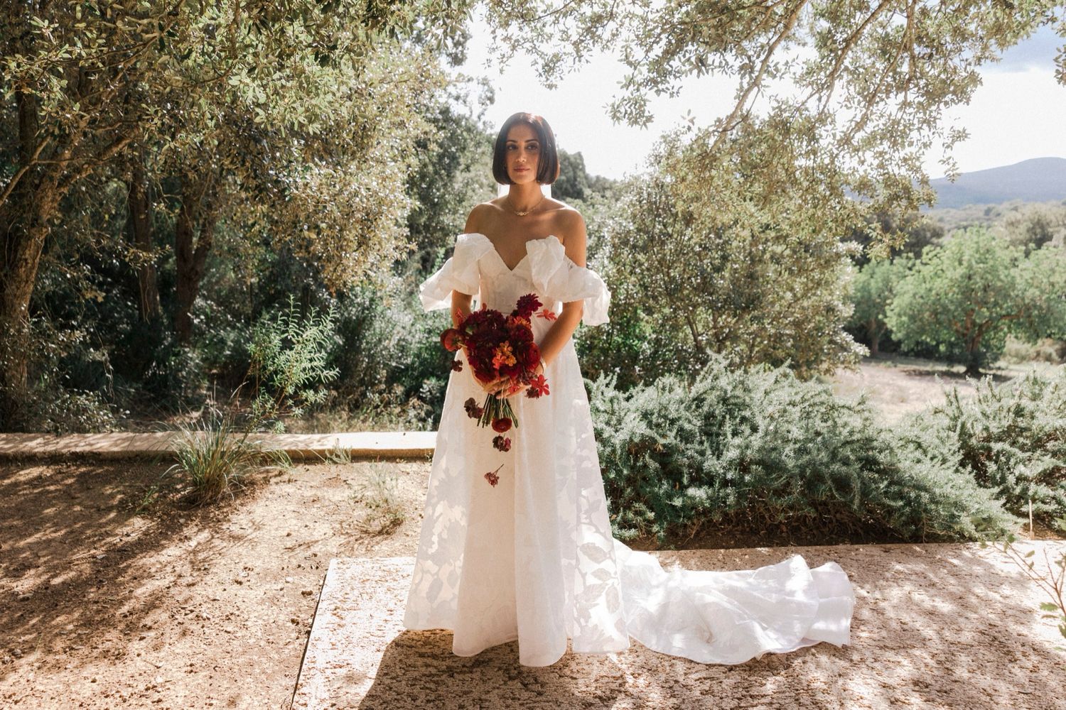 A series of outdoor wedding photos showing a bride in a white dress posing among trees and natural scenery.