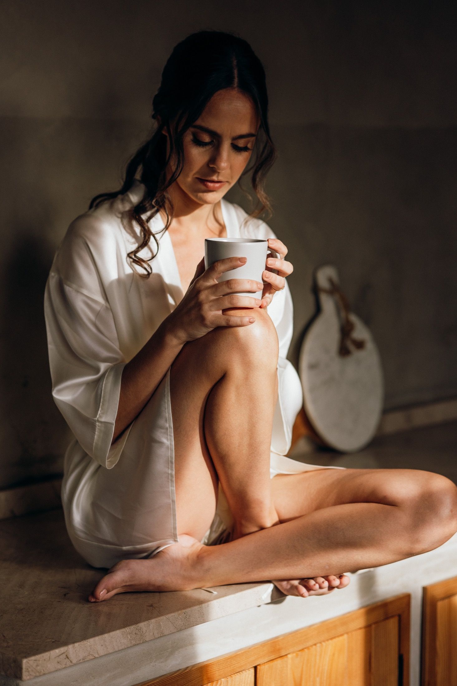 Artistic photo series showing someone in white shirt resting arms on wooden surface in moody lighting.