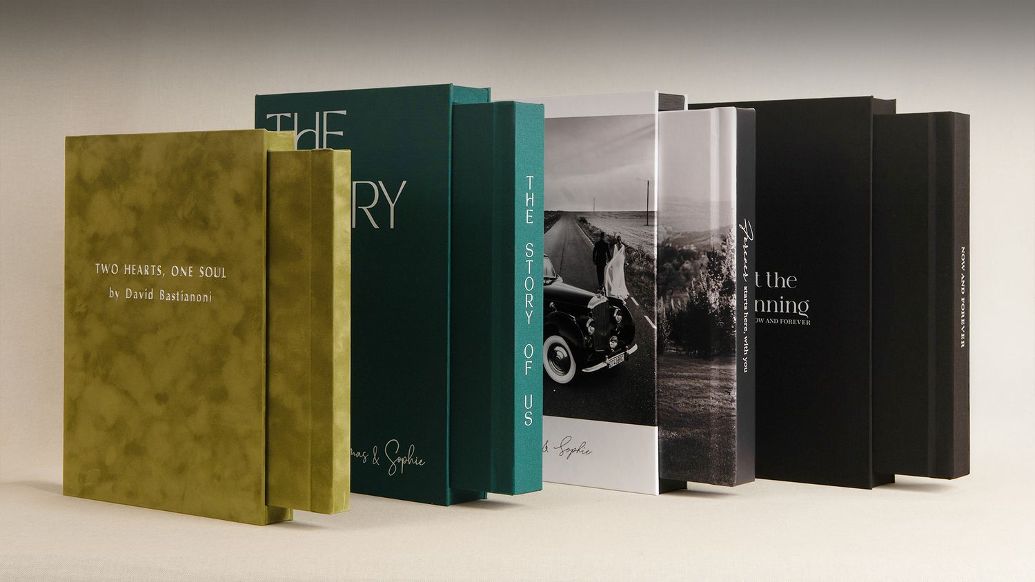 A row of hardcover books displayed in a minimalist style against a light background with shadows.