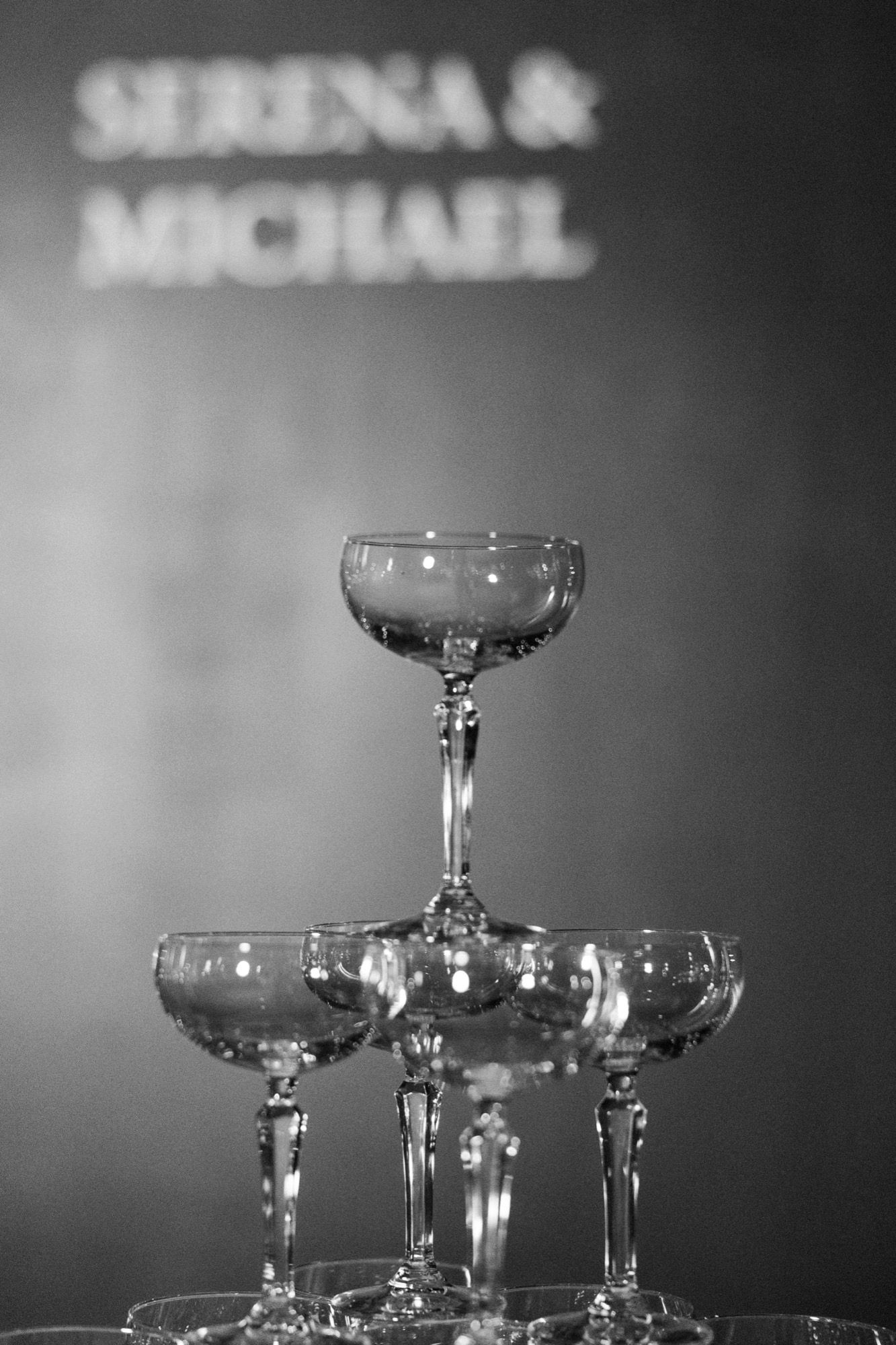 Crystal champagne coupes arranged in an elegant tower display.