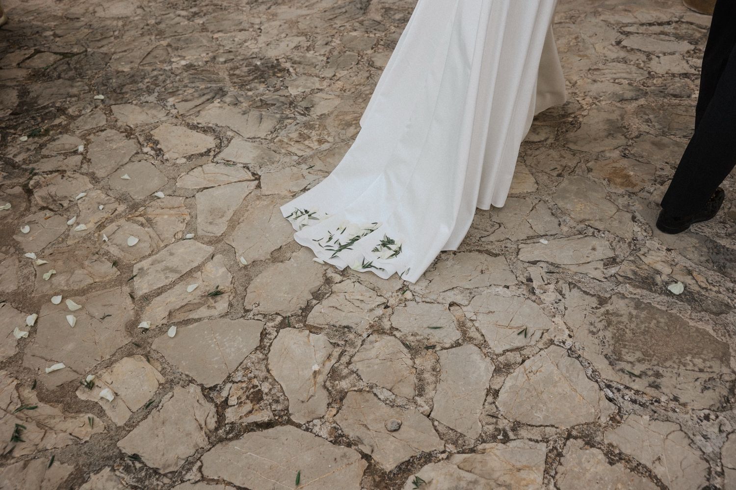 A stone path made of irregular cobblestones creates a rustic walkway texture in an outdoor setting.
