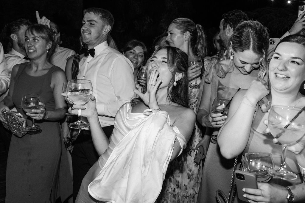 Candid moments of wedding guests enjoying themselves during an evening celebration.