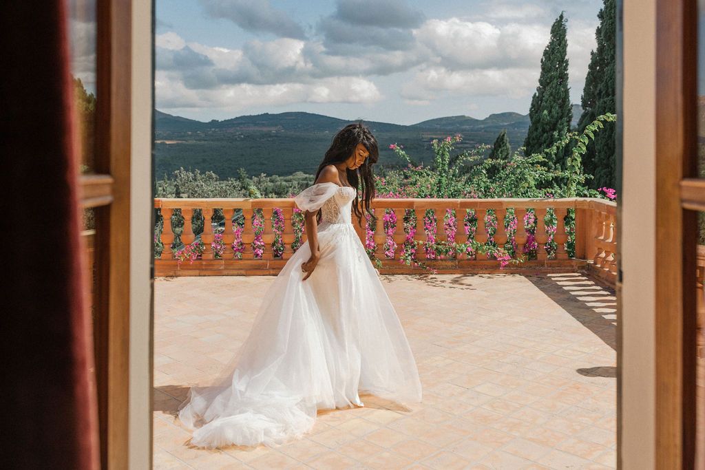 Scenic terrace overlooking mountains with elegant wedding decor and stone balustrades.