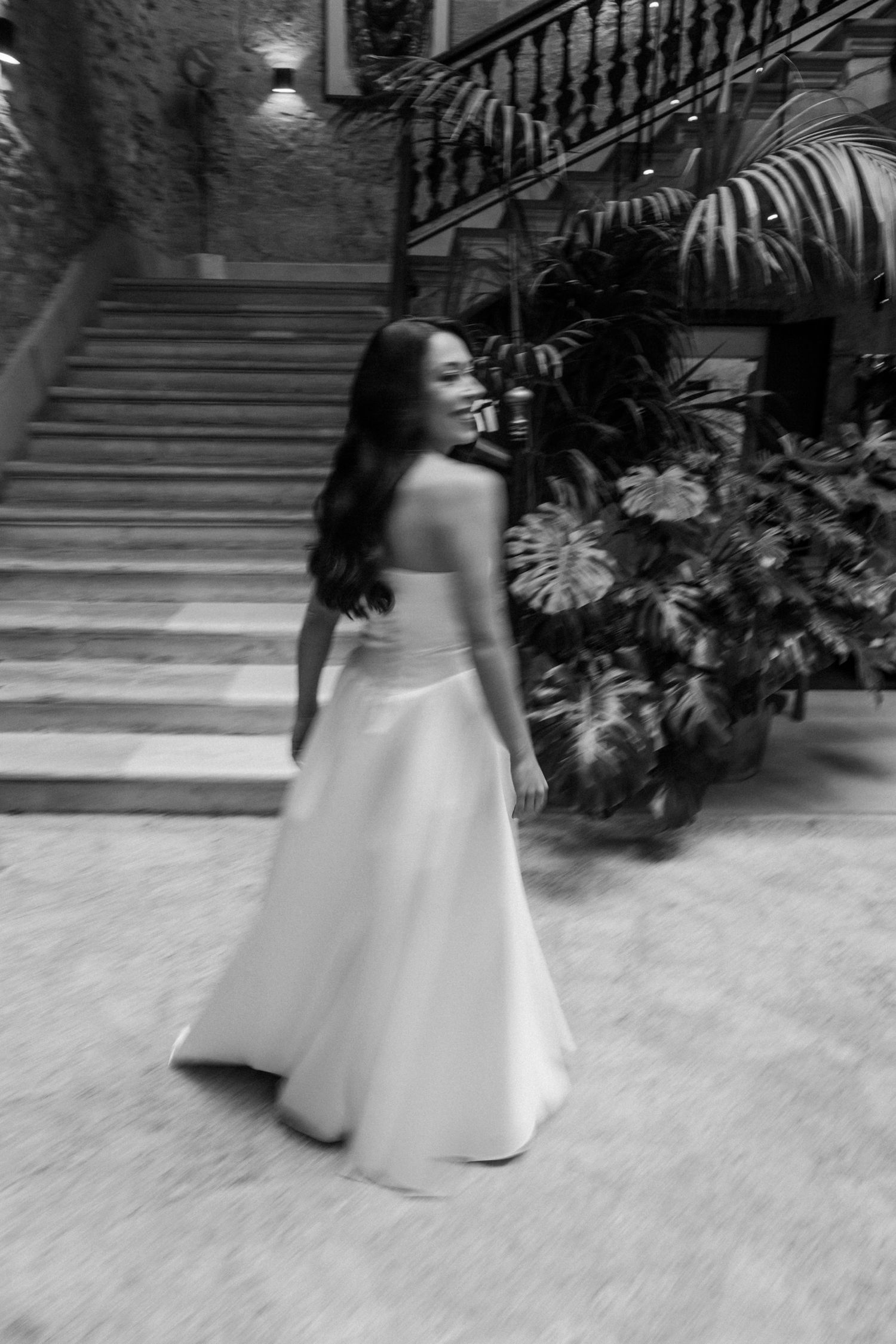 A sequence of black and white photographs showing a person in a flowing white dress twirling on outdoor steps.