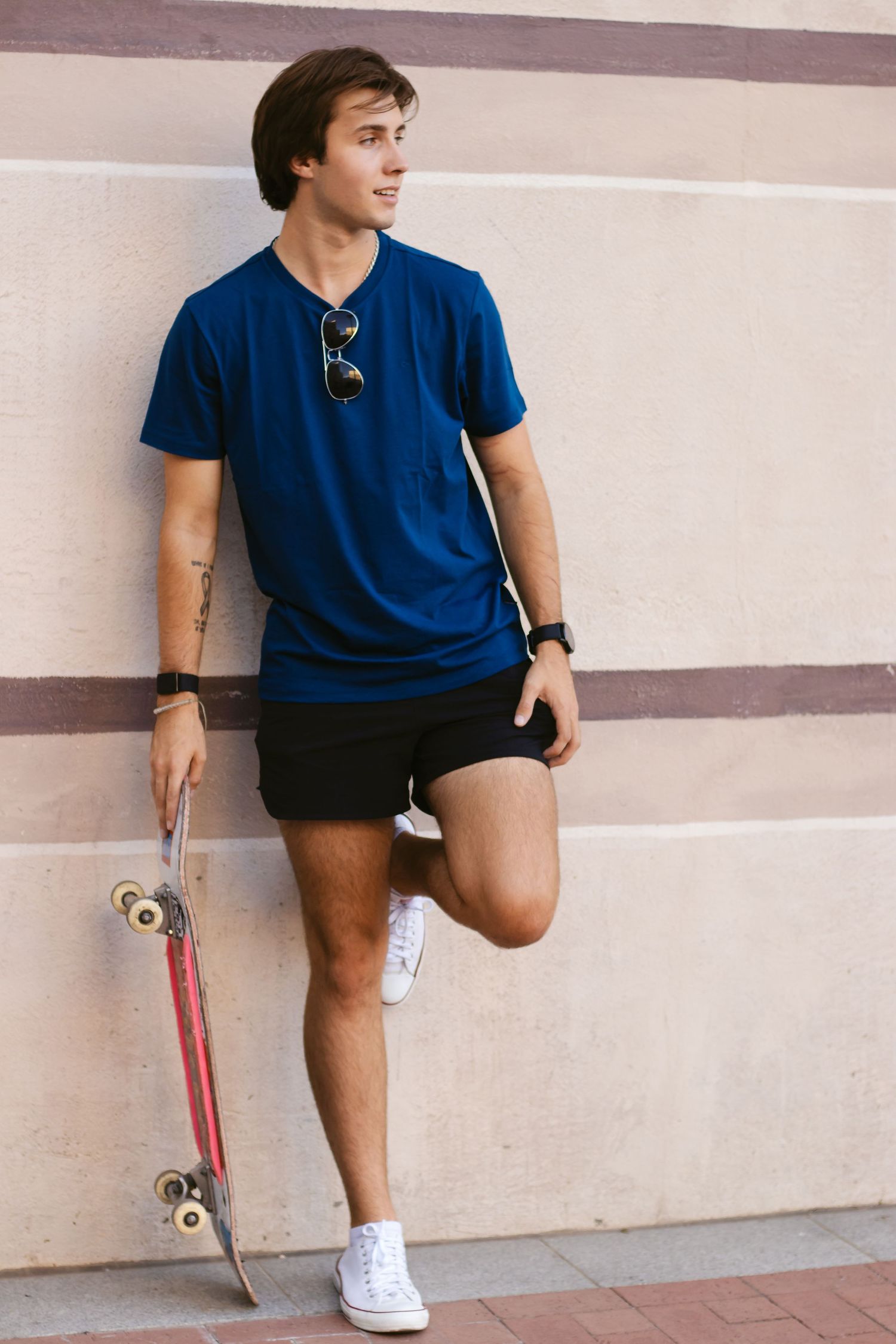 A young man leans against the wall during a portrait session with Fort Worth photographer, Lock and Key Photography.