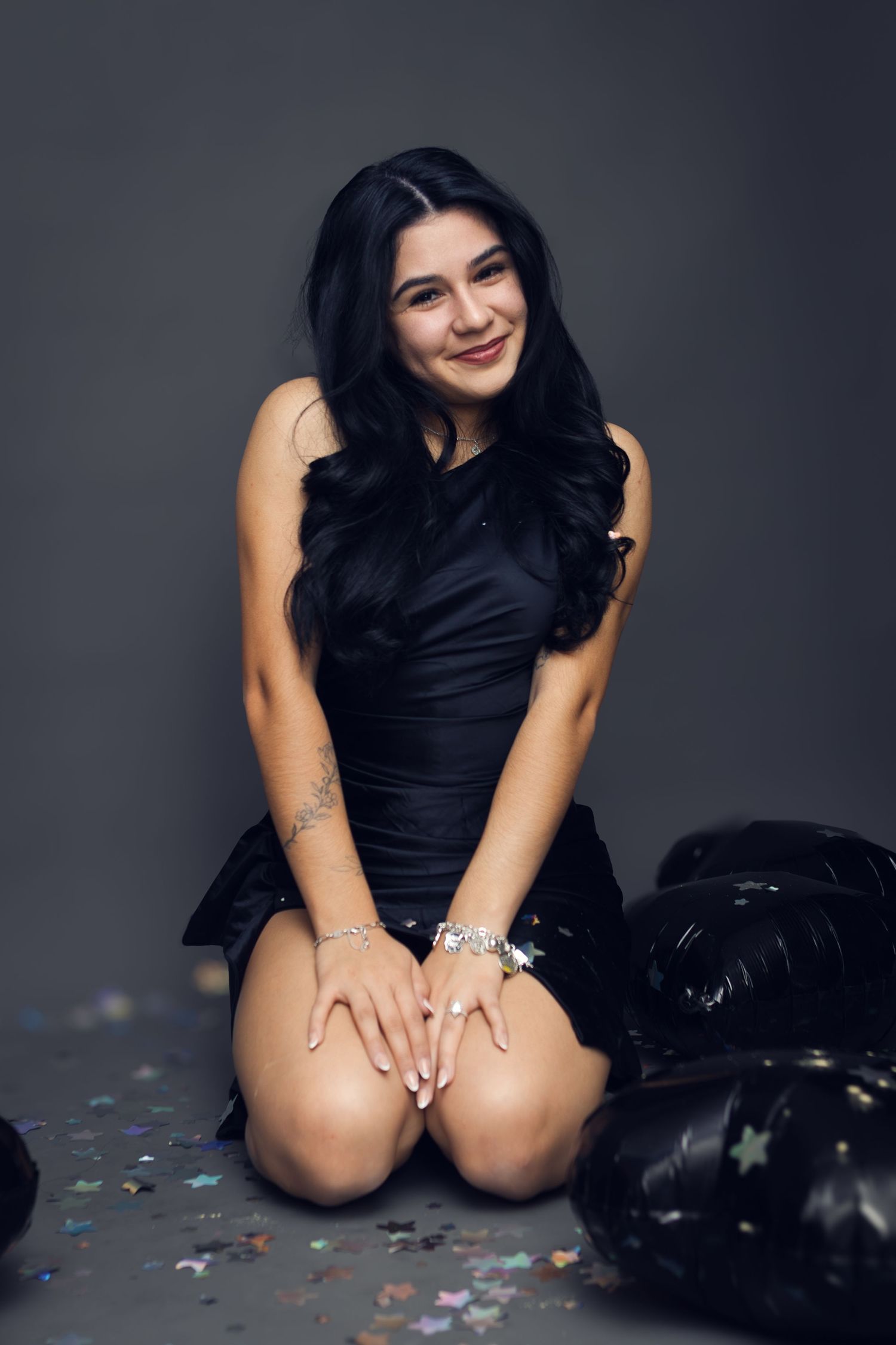 A young woman smiles during a 20th birthday portrait session in a Fort Worth, Texas studio.
