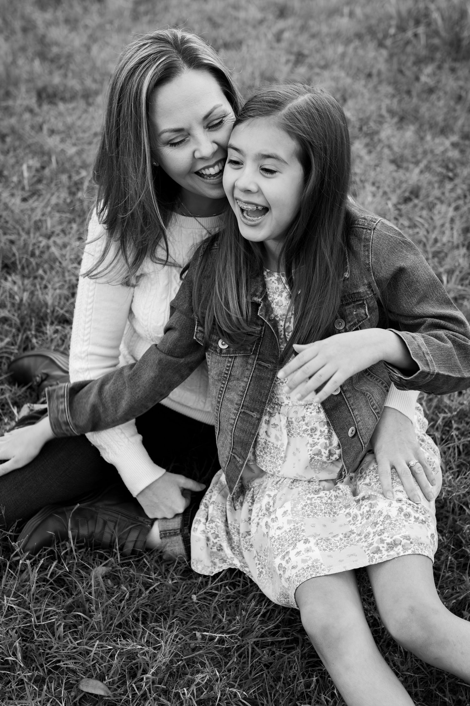 Black and white candid portrait capturing pure joy and laughter between two people.
