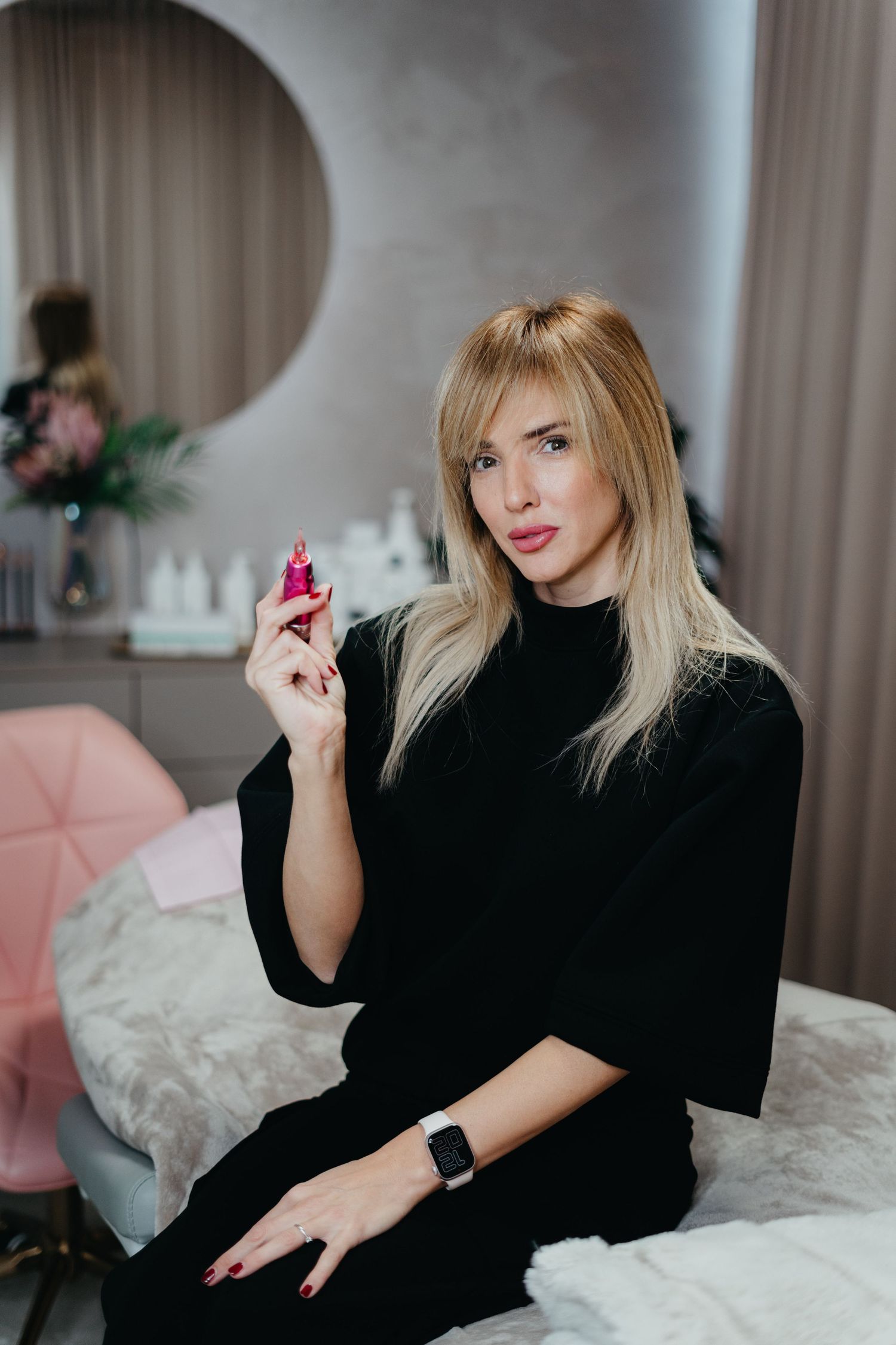 A series of glamour photos showing a person in a black turtleneck relaxing on white bedding with pink accents.