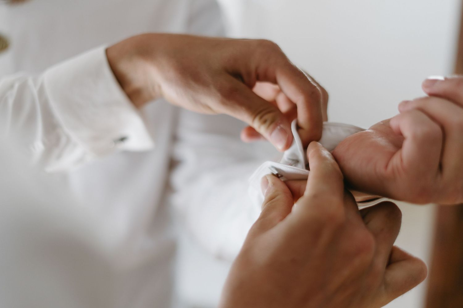 Close up shot of hands performing a manicure service on natural nails.