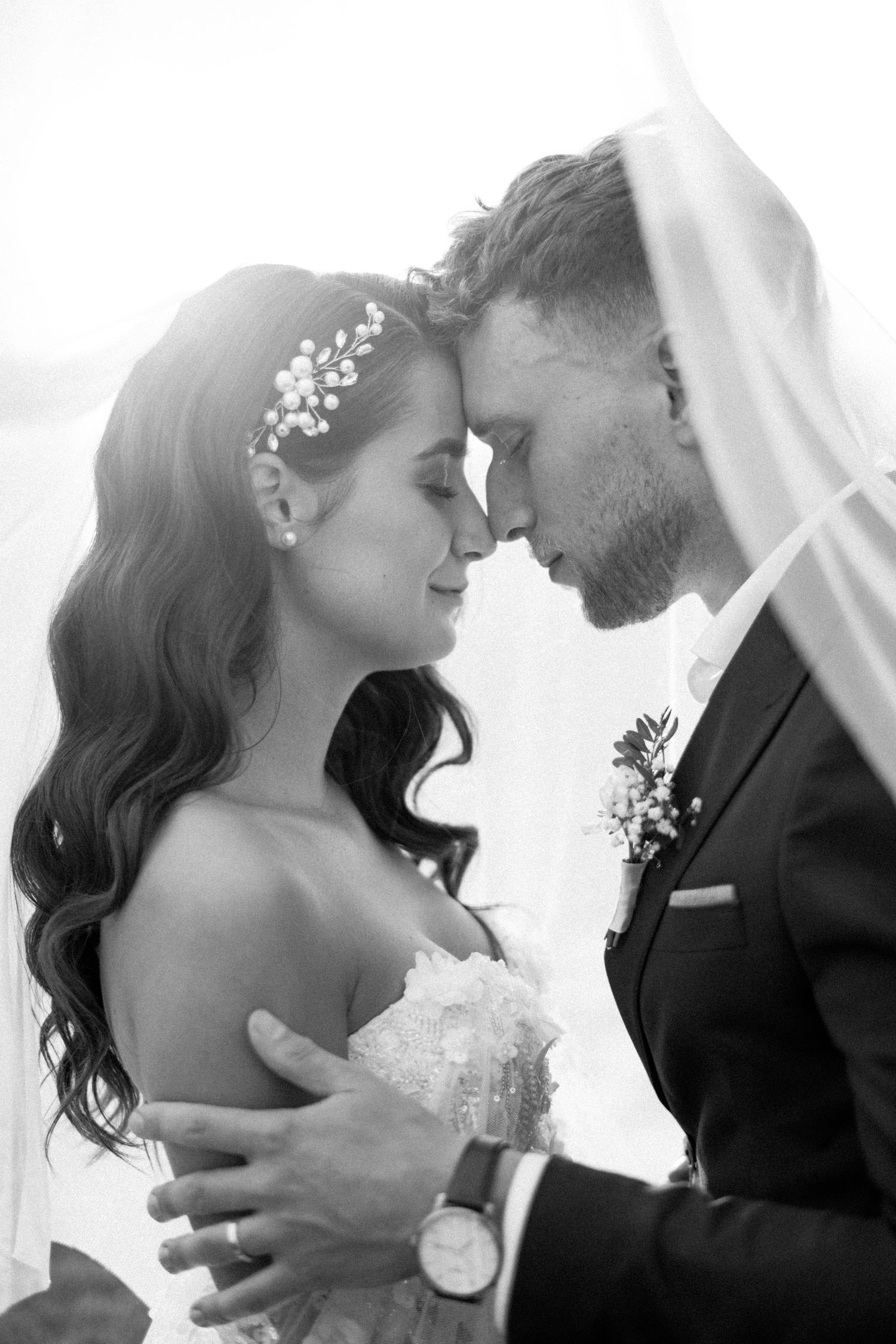 Black and white close-up shots of a tender wedding moment with romantic expressions.