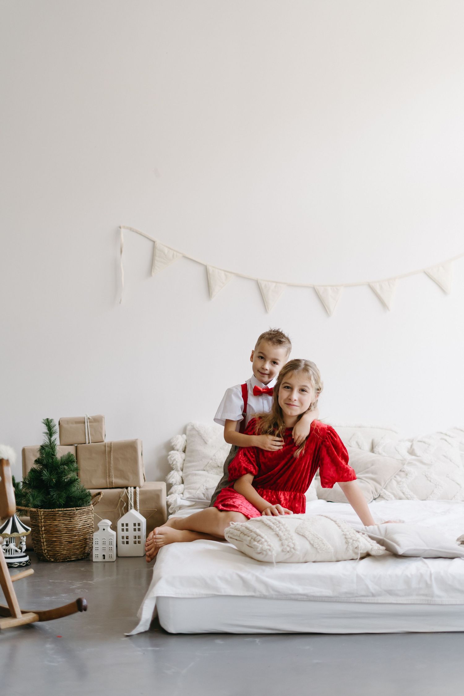 Holiday scene with white banner and Christmas decorations in minimalist room setting.