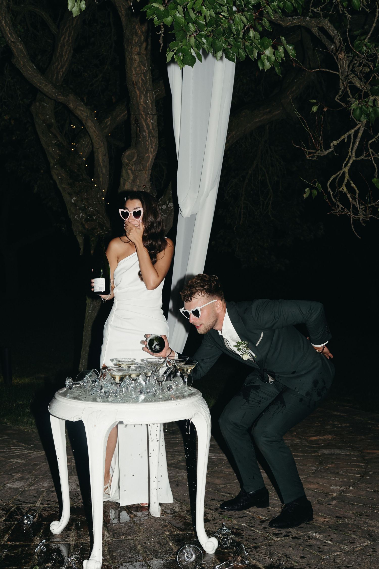 Wedding couple participates in a playful garter tradition ritual at their reception.