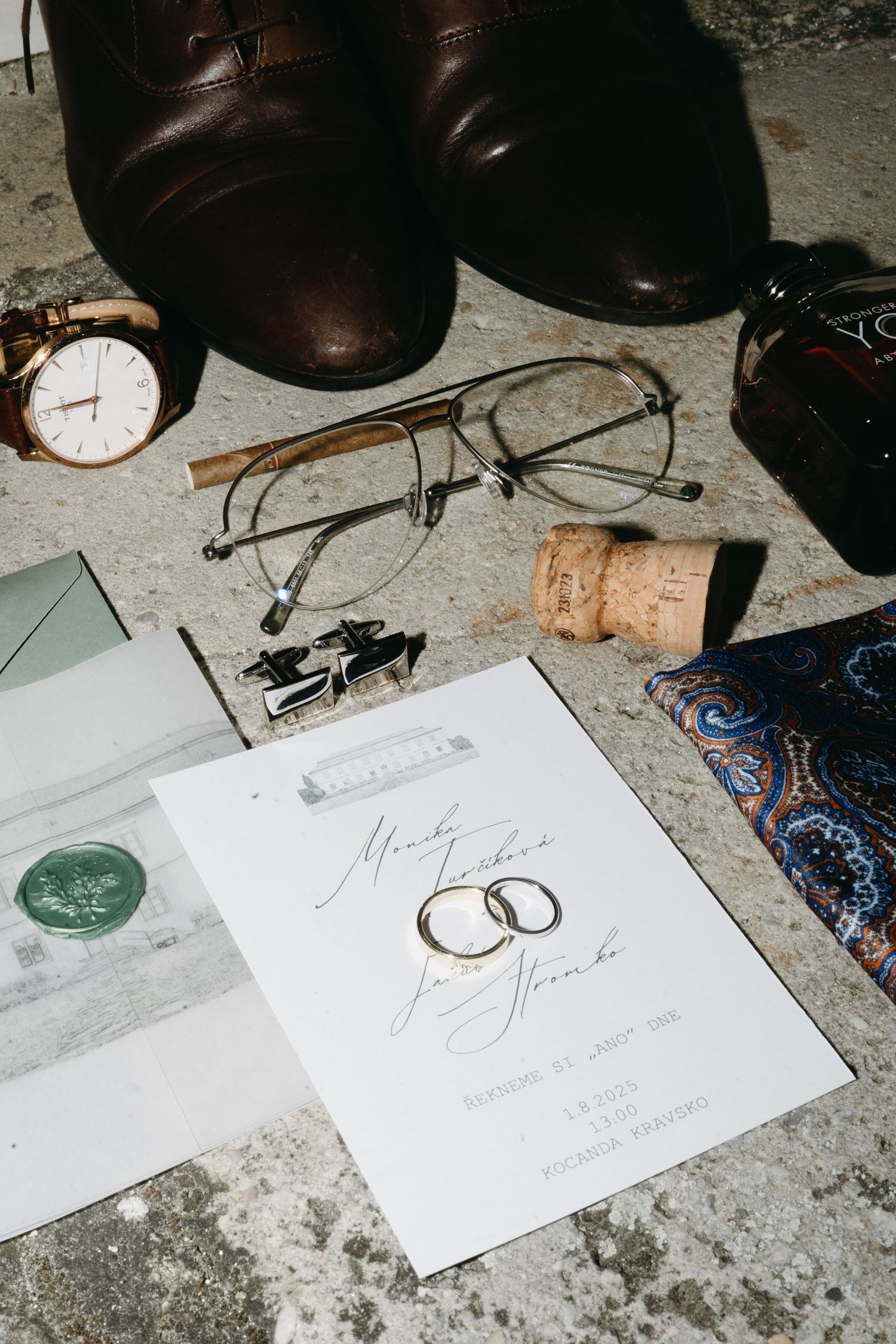 Wedding stationery with invitations and rings displayed alongside vintage accessories.