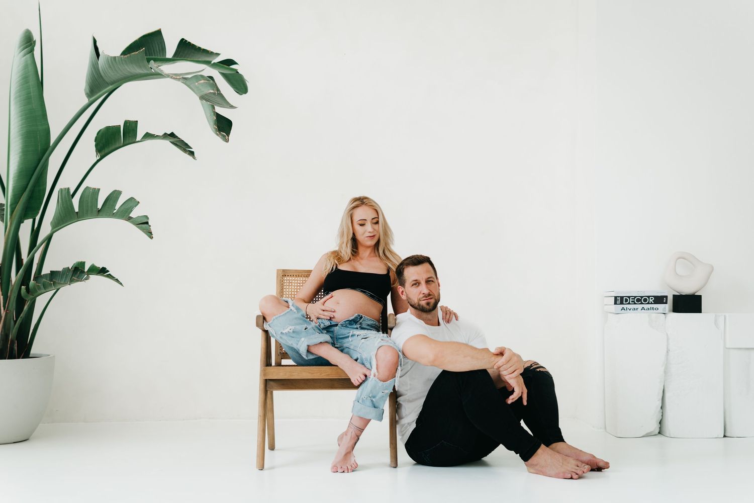A series of photographs showing people relaxing in minimalist white spaces decorated with green plants.