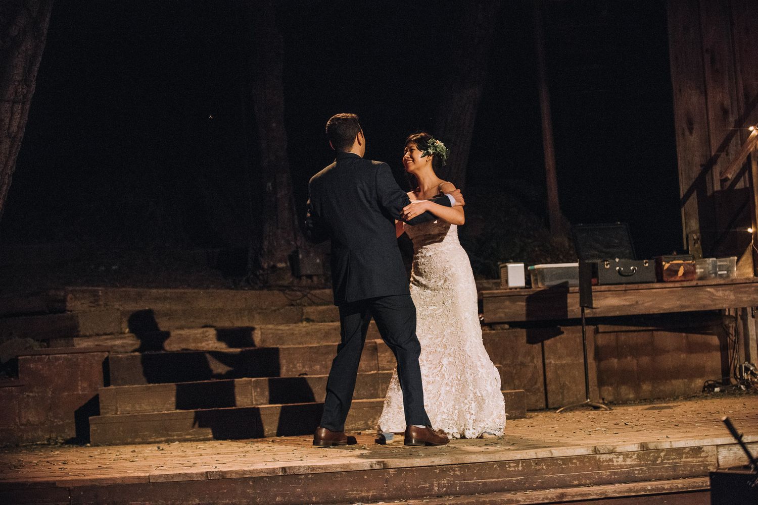 A couple shares an intimate dance moment on a rustic wooden porch at dusk.