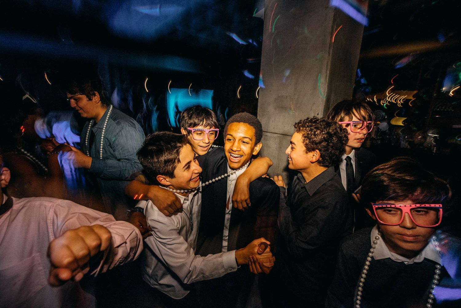 Young people dancing and enjoying themselves at a lively nightclub party.