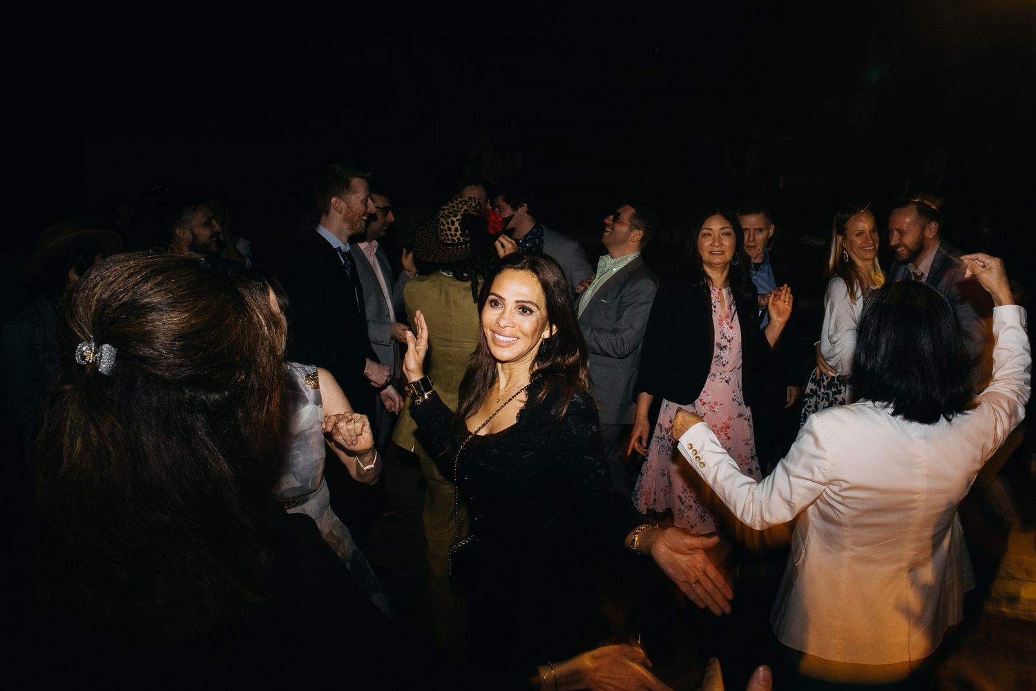 People dancing and socializing at a lively party or nightclub event.