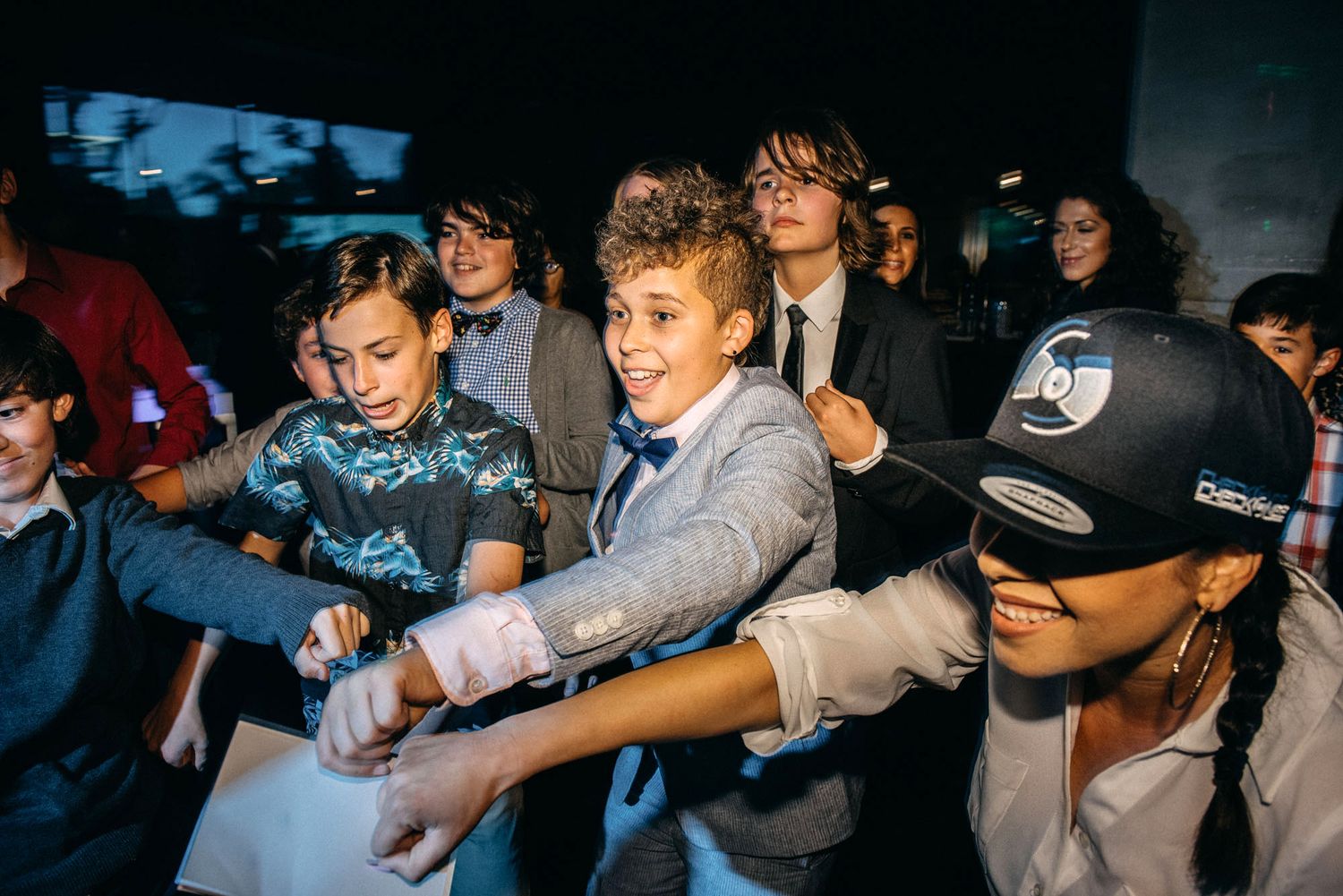 Teenagers dancing and having fun at a school dance or party.