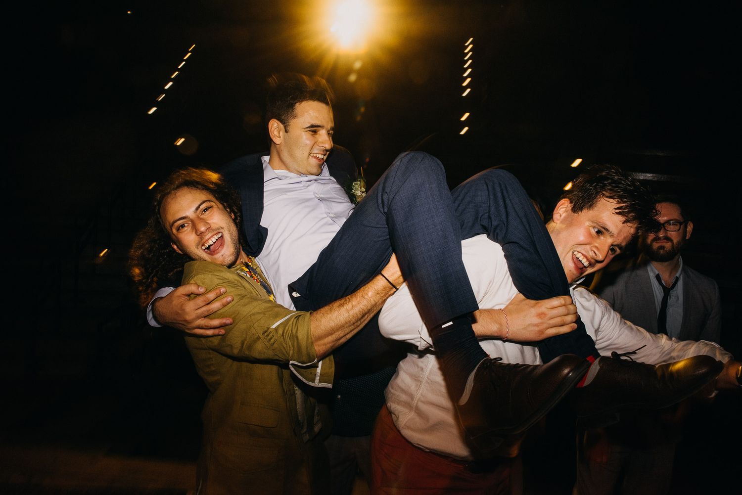 A series of candid nighttime photos showing people laughing and embracing at what appears to be a social gathering.
