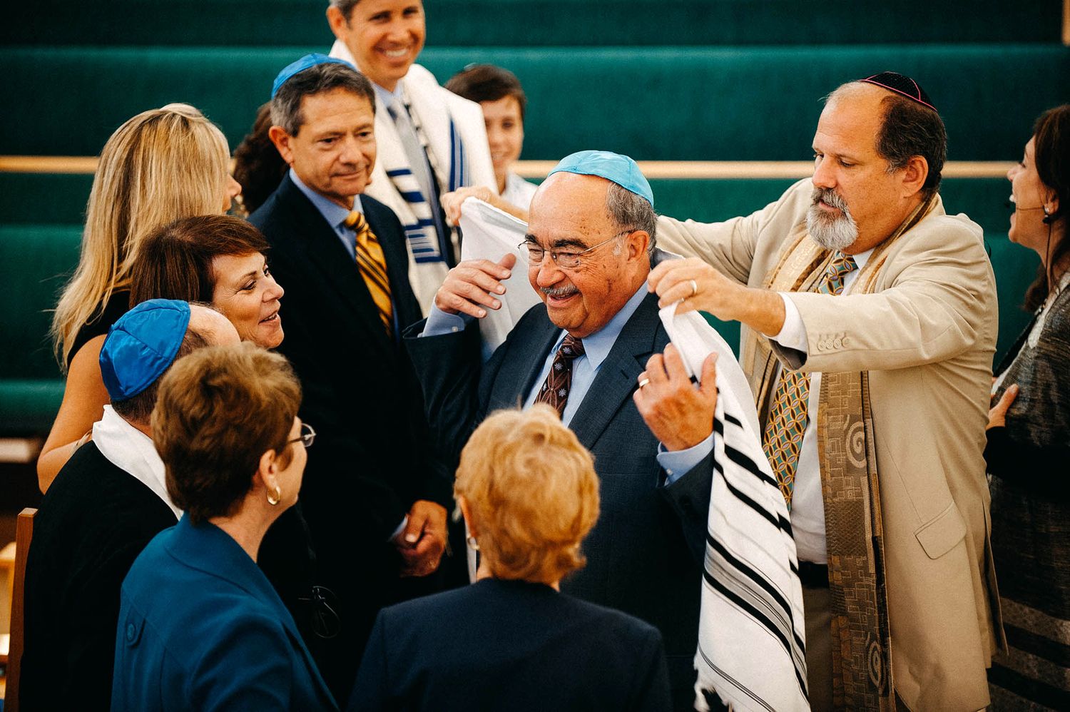 A gathering of people in a huddle having an animated discussion at a formal event.