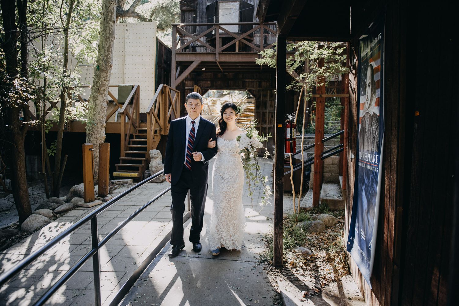 Sunlit walkway with wooden beams and rustic architecture creates a romantic wedding venue atmosphere.