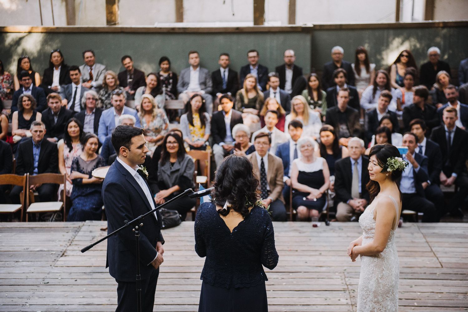 Wedding party members perform a choreographed dance routine on outdoor steps during a celebration.