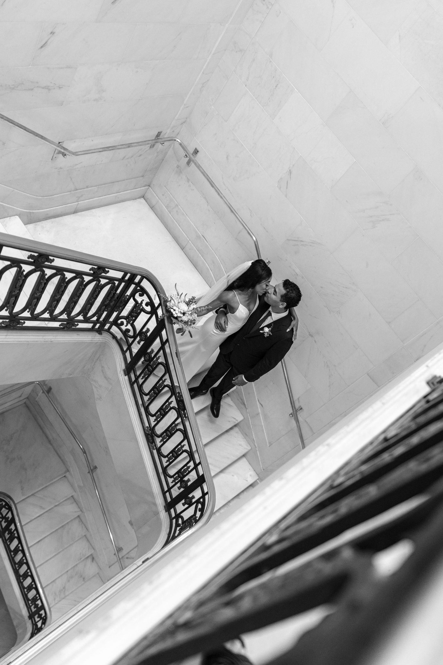A black and white artistic photo series showing someone climbing up stairs with decorative railings from different angles.