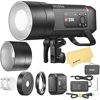 Professional photography studio lighting equipment including flash units, diffusers, and power supplies arranged in a row.