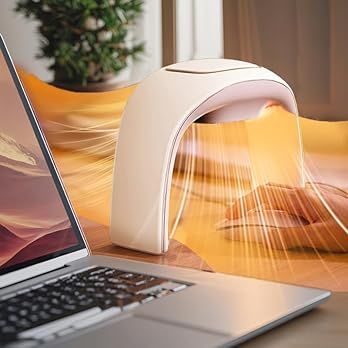Laptop keyboard illuminated by warm sunlight streaming through window with potted plants in background.