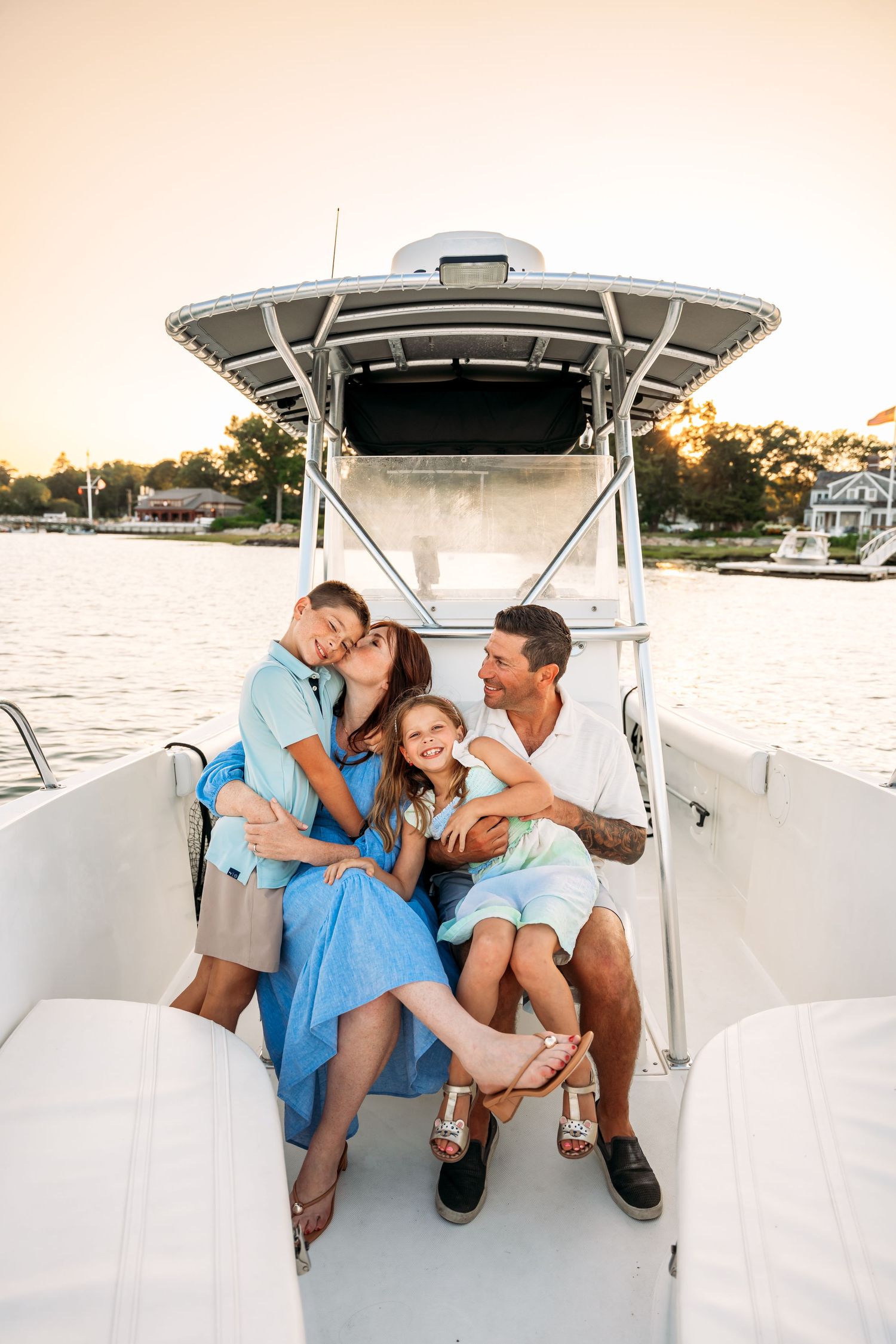 Family enjoying quality time together on a boat during sunset on the water.