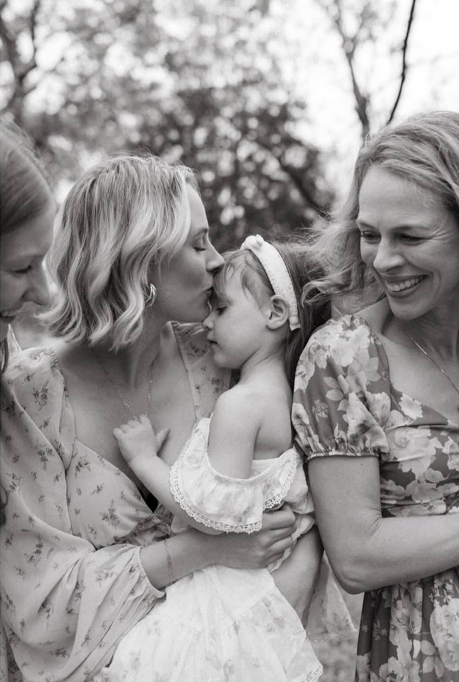 A heartwarming black and white photo series showing tender moments between people in floral dresses outdoors.