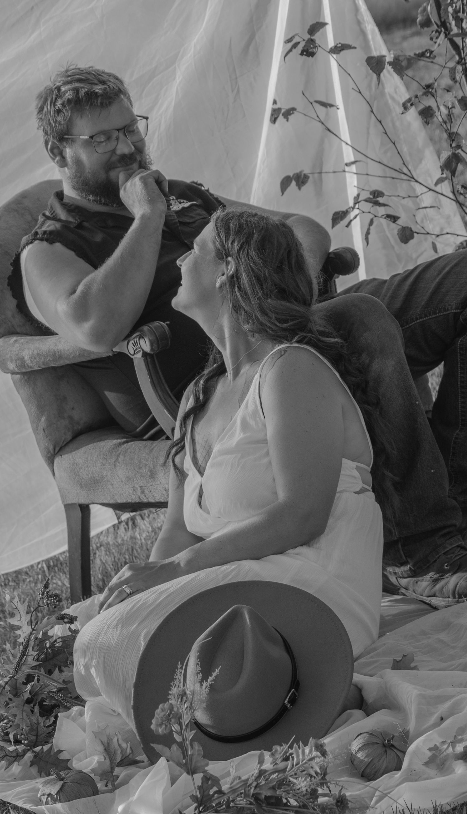 A romantic black and white photo series showing a couple embracing in a garden setting.