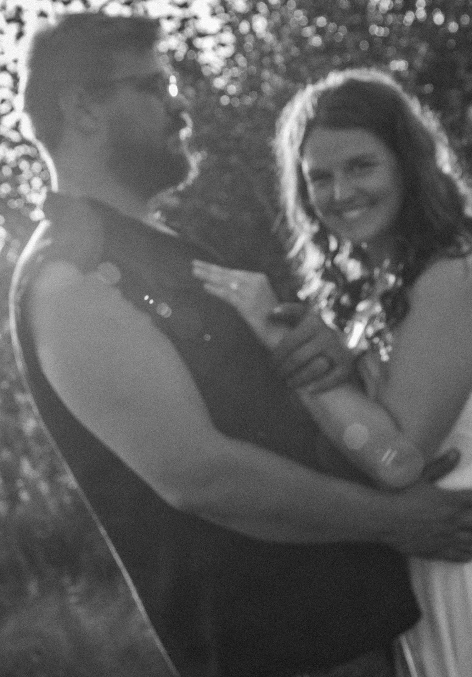 Dancing couple shares a joyful moment together in a black and white candid photo sequence.