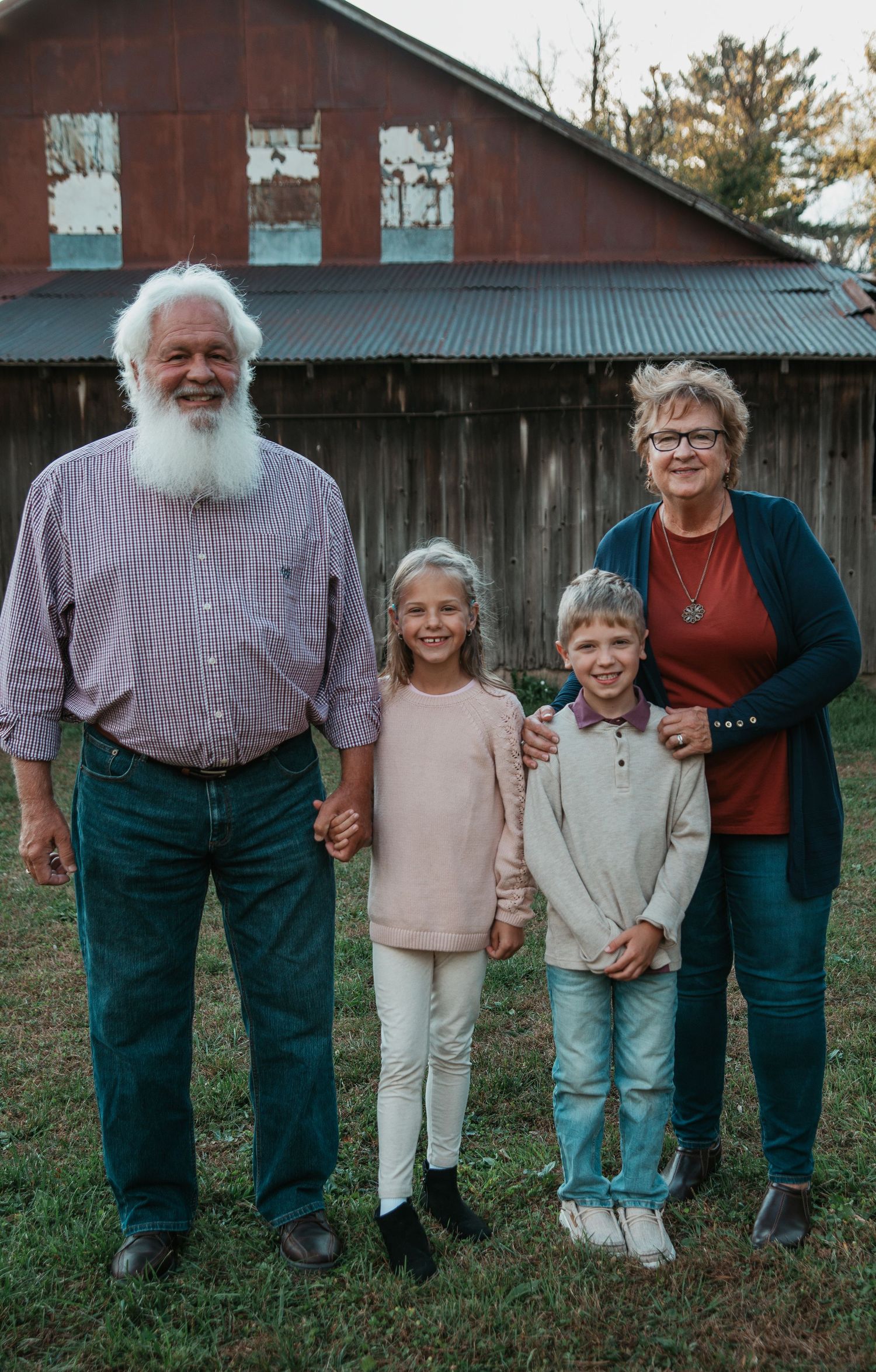 A sequence of five similar photos showing people standing together outdoors against a rustic barn backdrop.