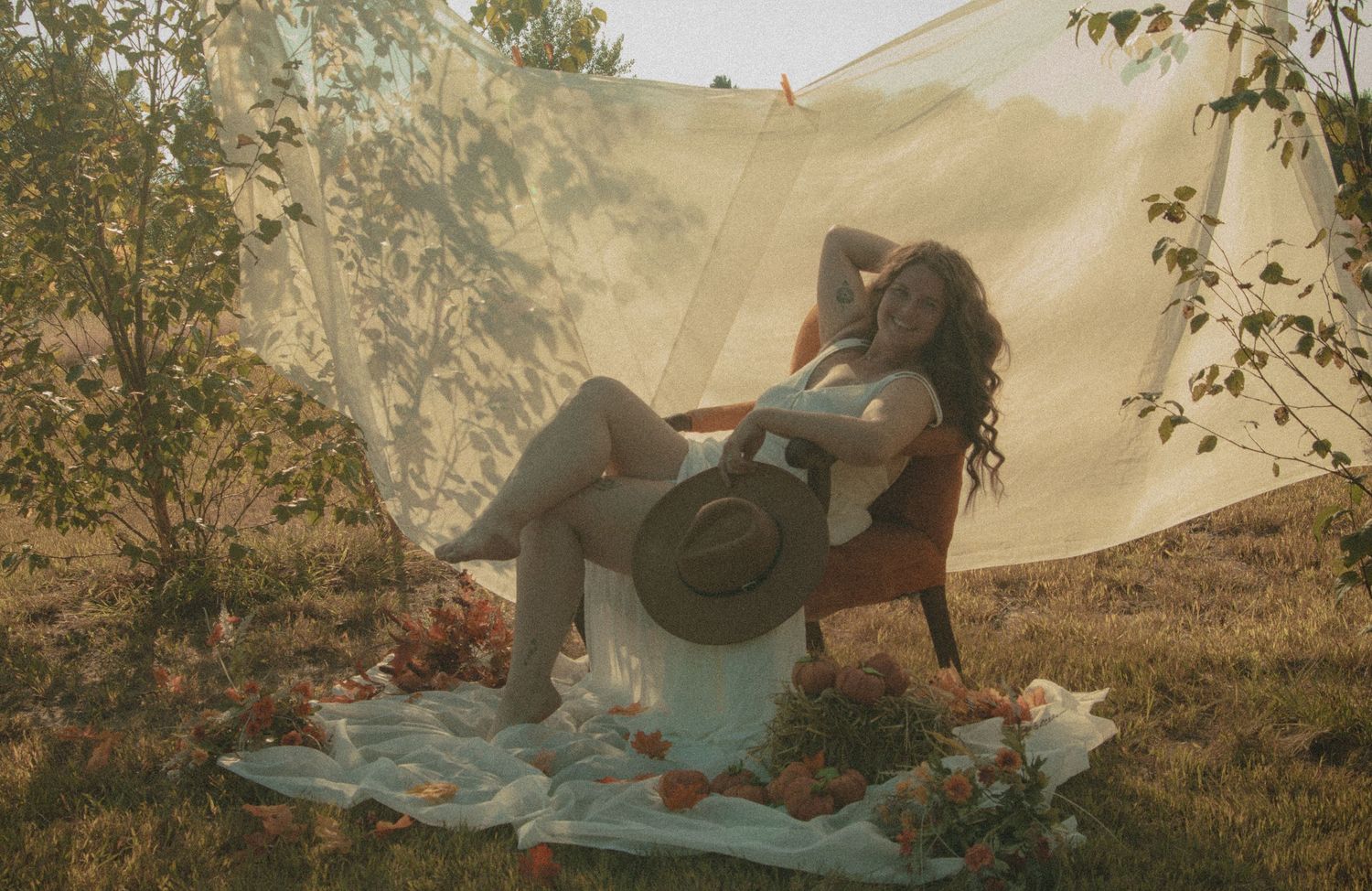 A series of candid camping photos showing people relaxing on blankets under a canvas tent in a natural setting.