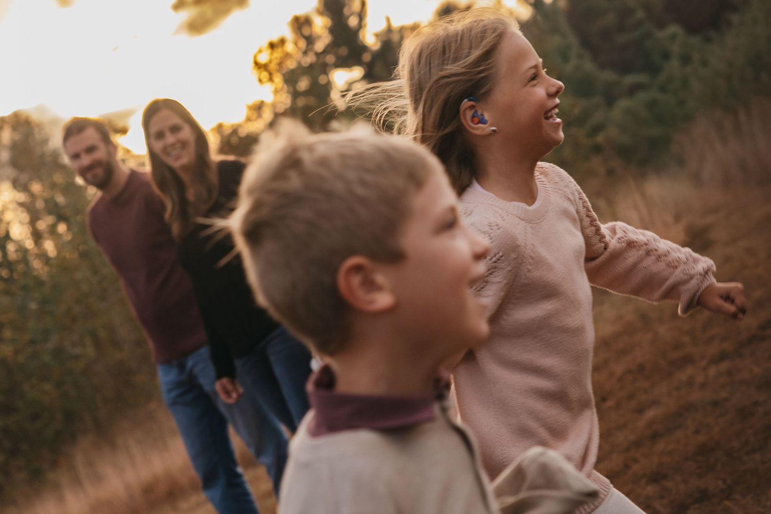 A collection of candid family moments captured during golden hour showing joyful expressions and natural interactions outdoors.
