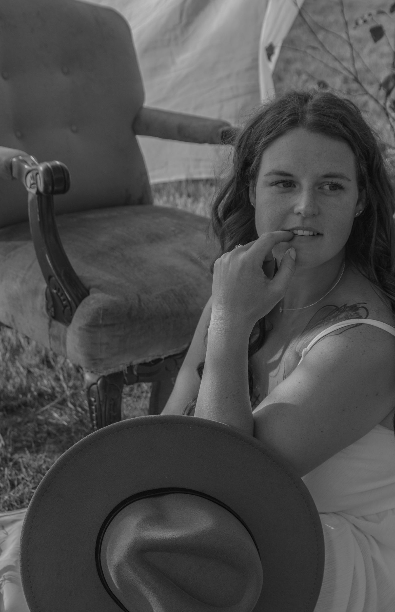 Four black and white photos show someone lying down smoking a cigarette in a relaxed outdoor setting.