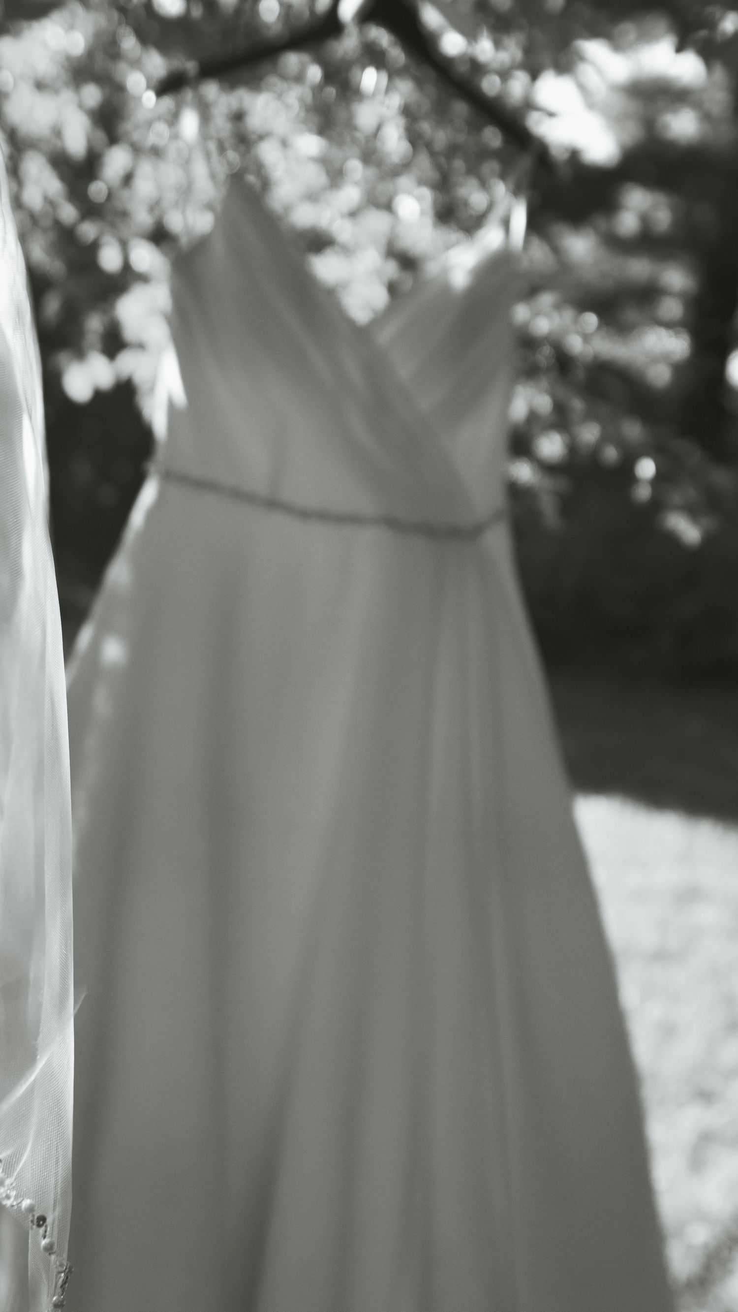 White laundry hanging on a clothesline outdoors creates a peaceful domestic scene in black and white photography.