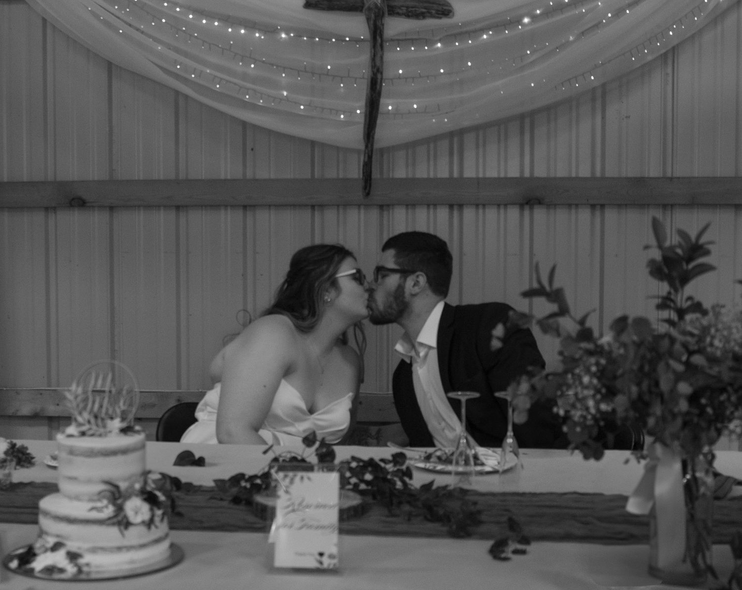 Black and white wedding reception photos show couples dancing under twinkling string lights.
