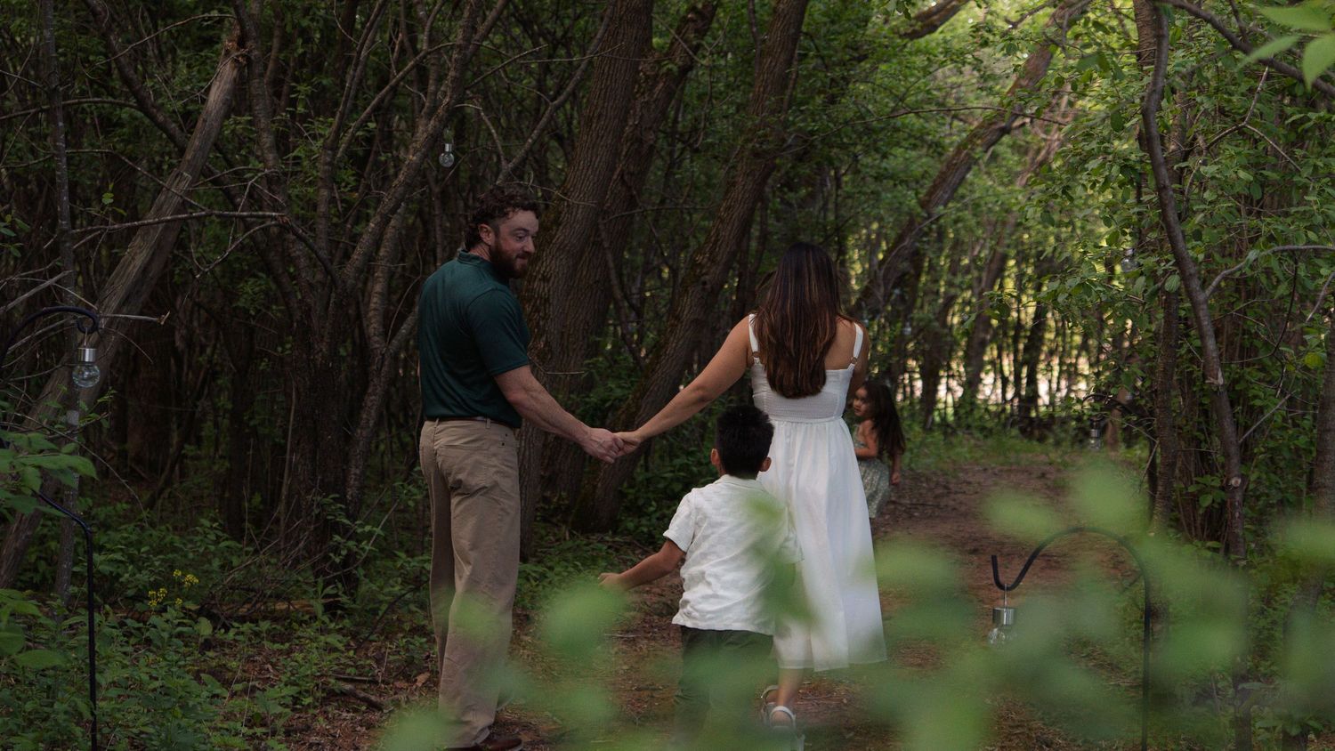 A series of candid outdoor photos showing people walking and enjoying nature along a wooded path in summer.