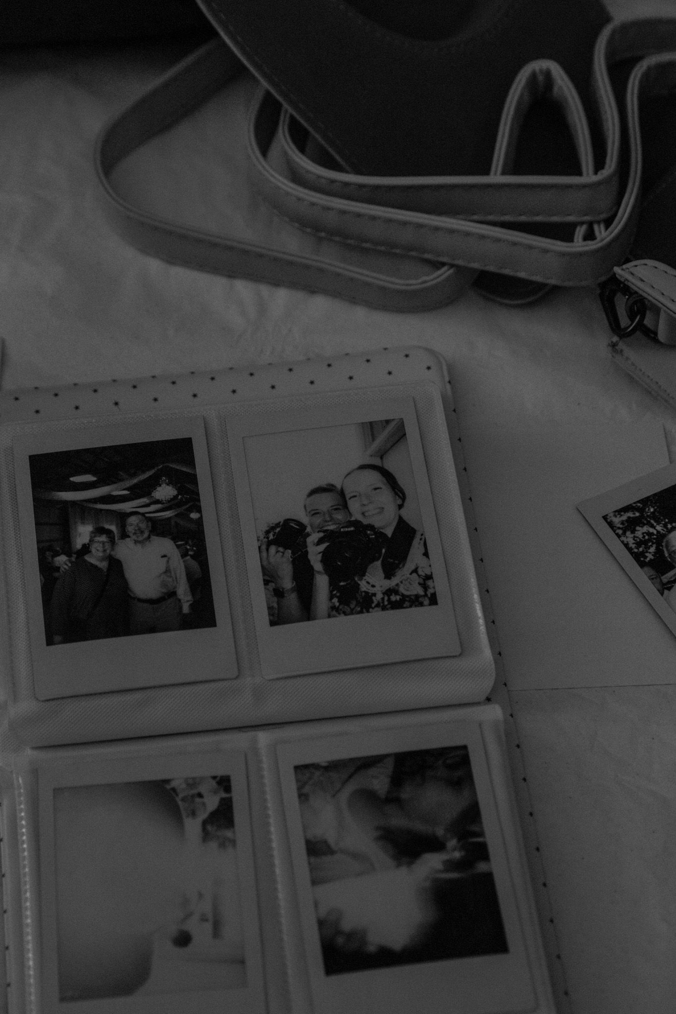 A collection of black and white photographs displayed in a grid arrangement with what appears to be camera equipment above.