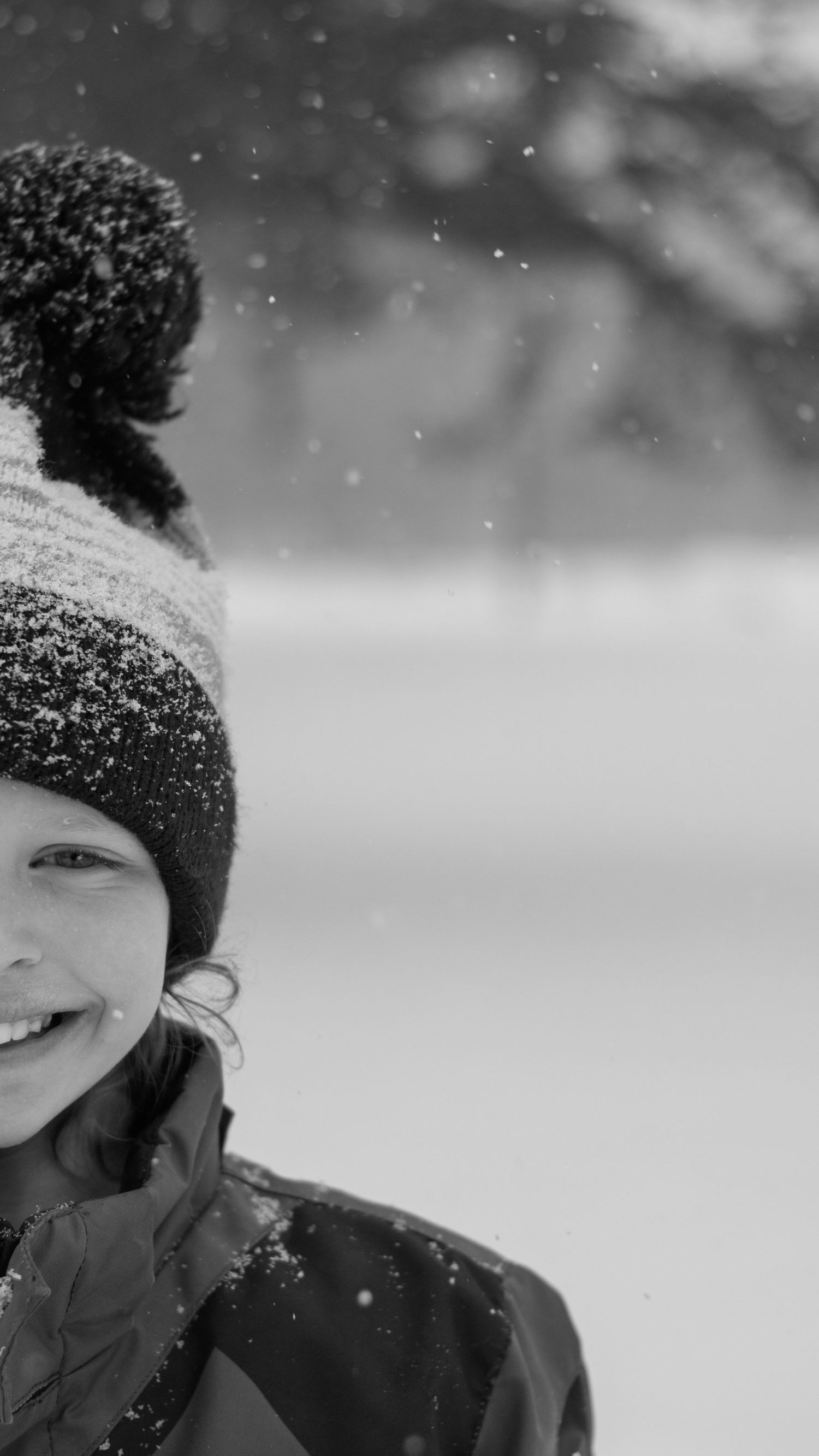 Close-up black and white winter portraits showing joy and laughter in snowy conditions.